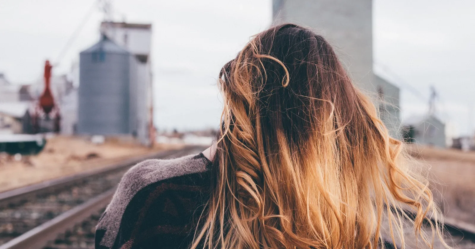 Long ombre waves seen from behind beside railway tracks