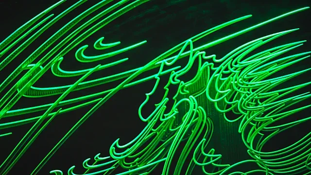 Neon green light trails on a black background