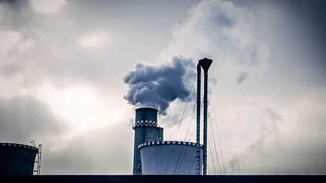 Industrial silos under a cloudy sky