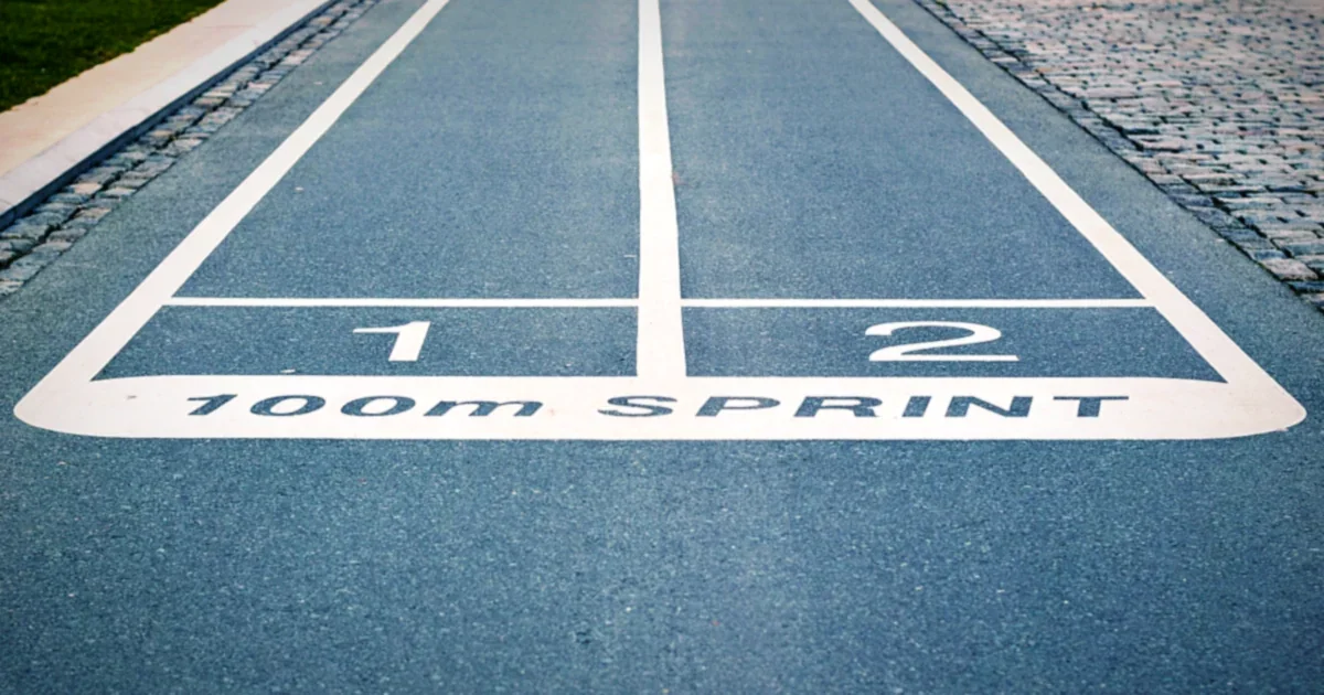 Sprinters racing down a running track