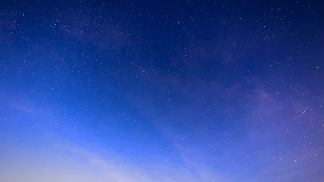 Deep blue night sky with scattered stars