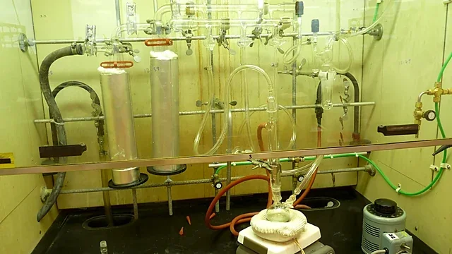 Glass vacuum manifold and flasks in a chemistry fume hood