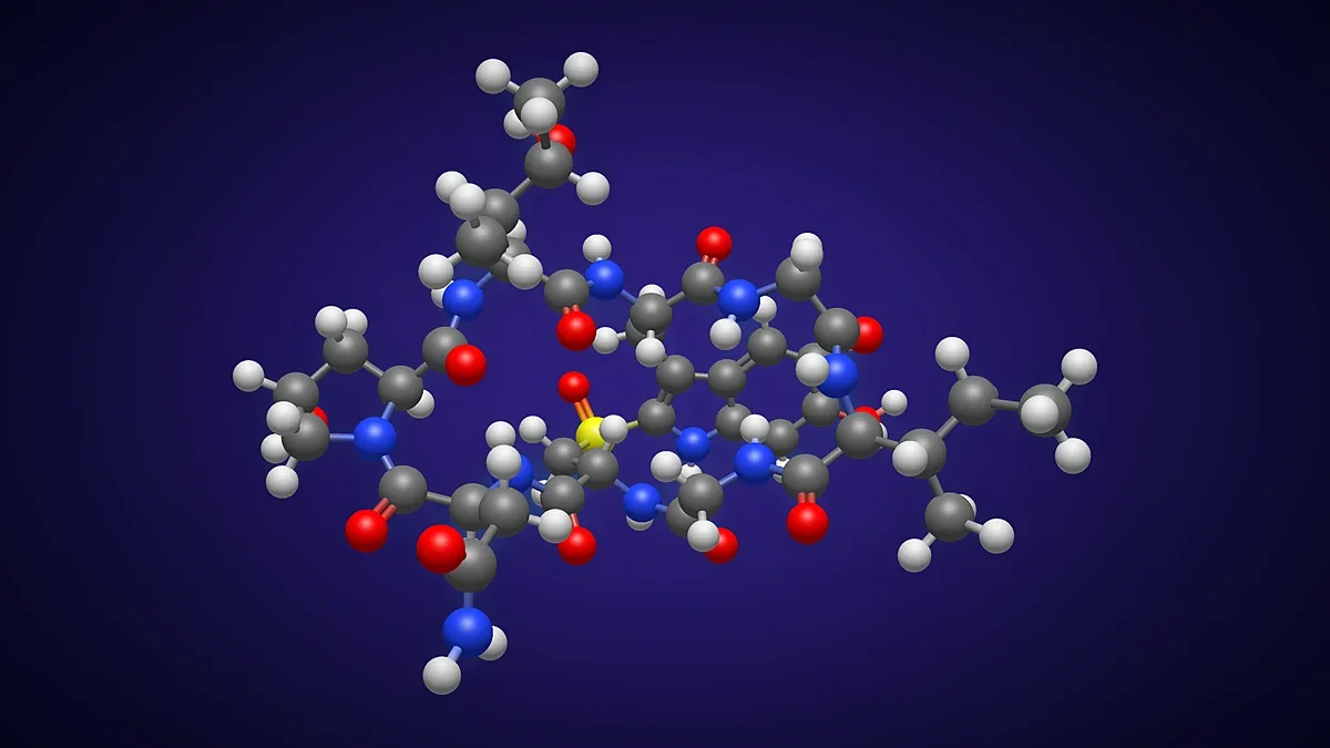 Ball-and-stick 3D render of a cyclic peptide glowing on a deep blue background