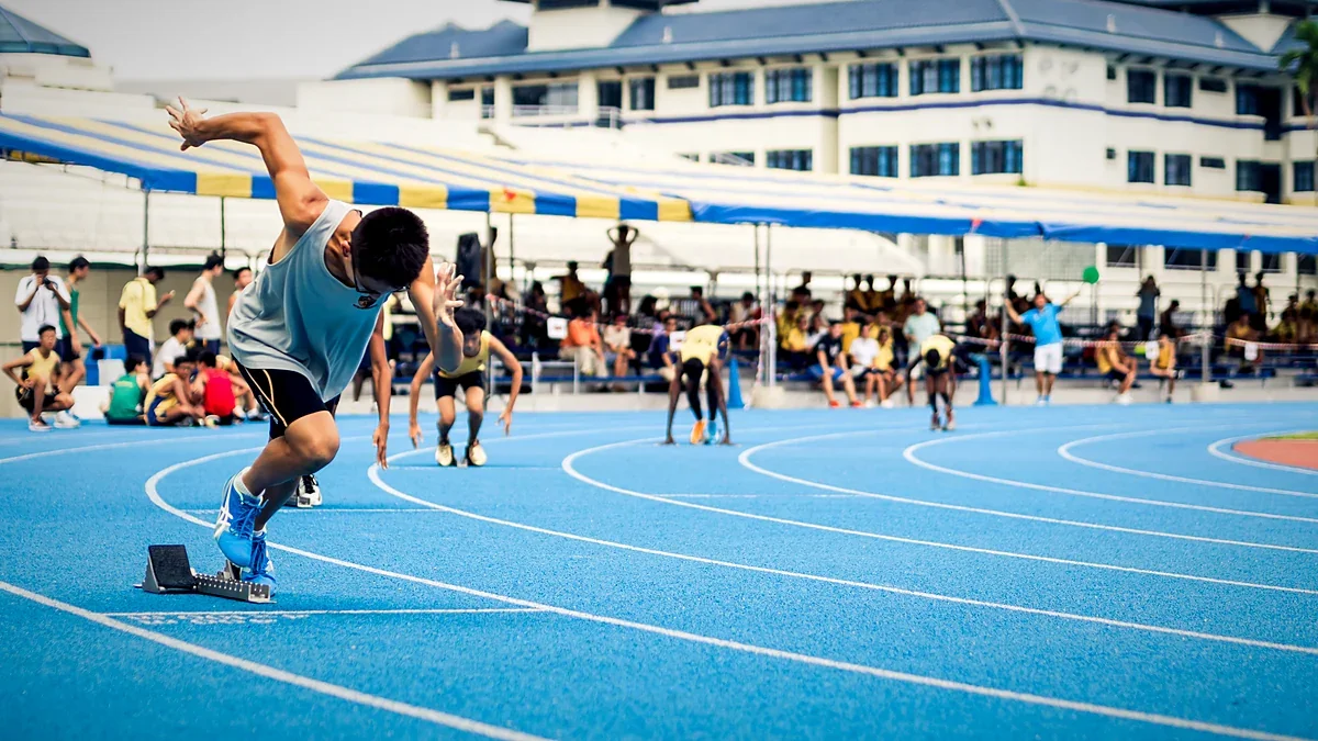 Sprinters racing down a running track