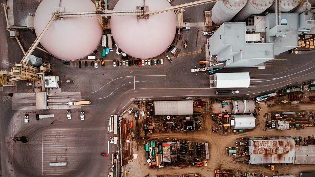 Aerial view of an industrial processing facility with machinery and roads
