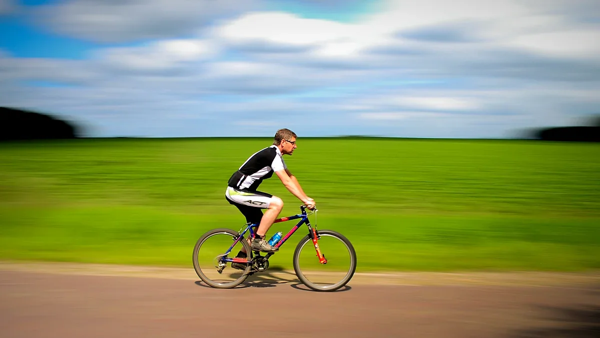Cyclist riding along an open road at speed