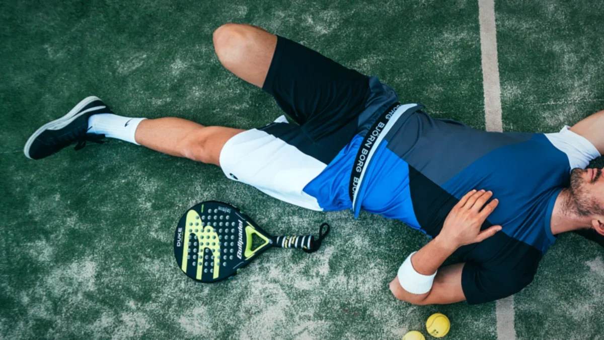 Tennis athlete striking a forehand on an outdoor lawn