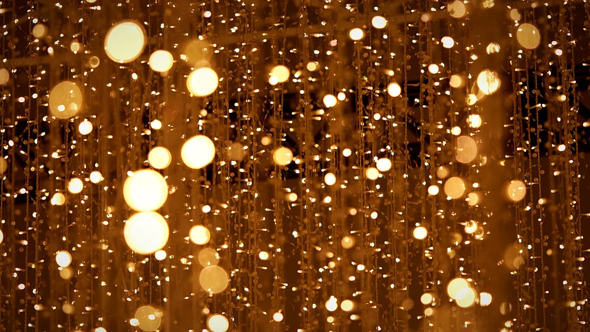 Soft golden bokeh lights scattered across a dark backdrop