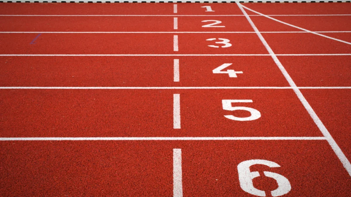 Sprinters racing along a curved athletics track