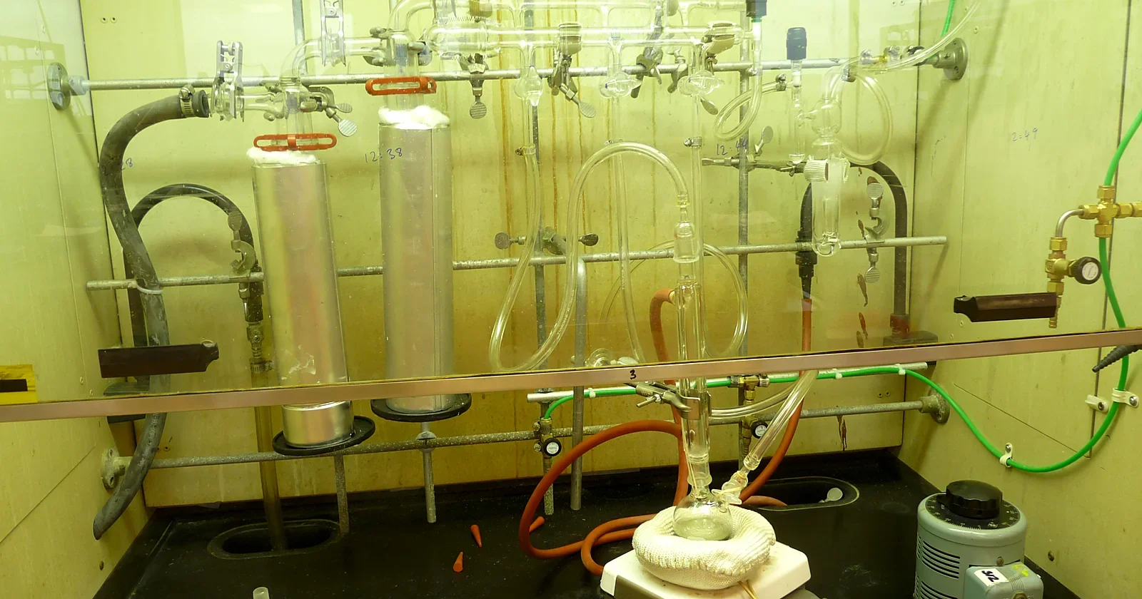 Glass vacuum manifold and flasks in a chemistry fume hood