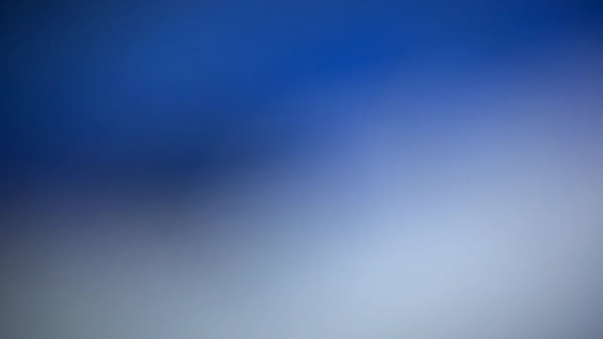 Soft blue abstract light streaks across darkness