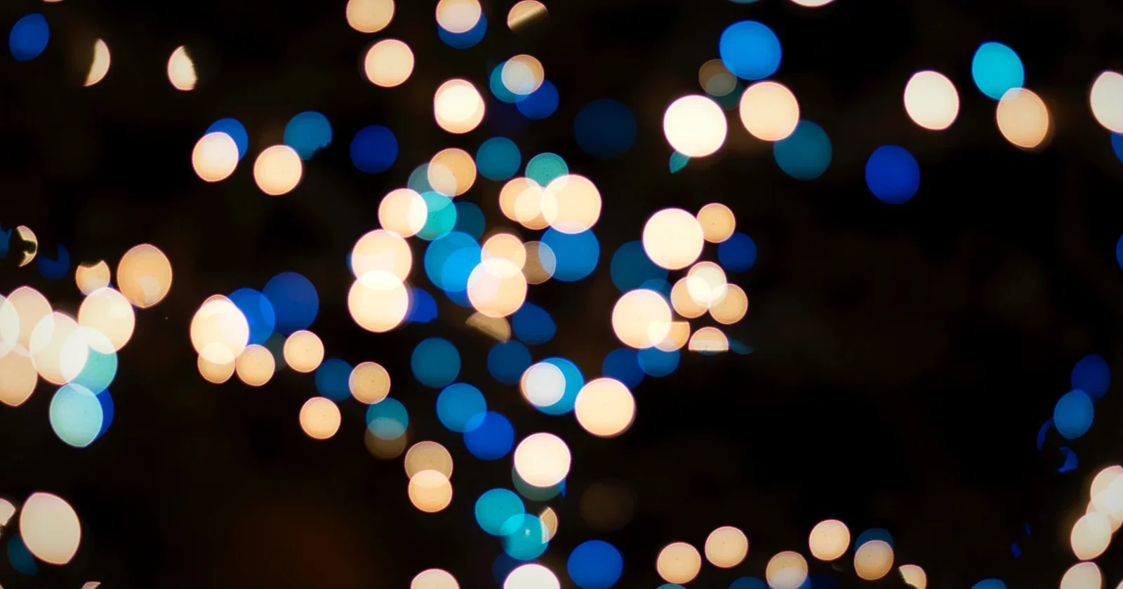 Warm festival bokeh lights glowing in darkness