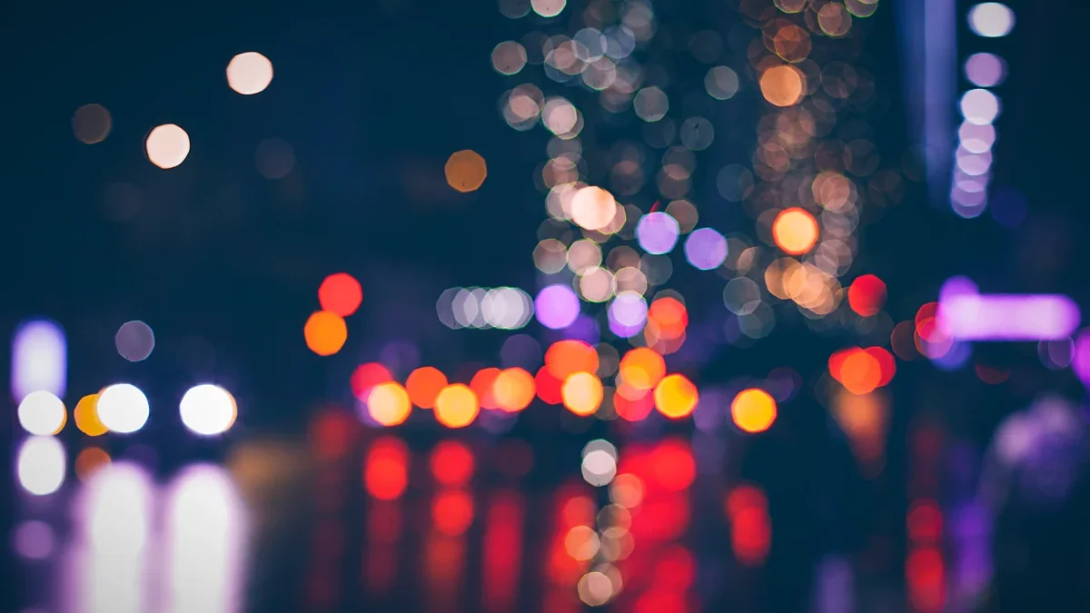 Scattered holiday bokeh lights against a dark field