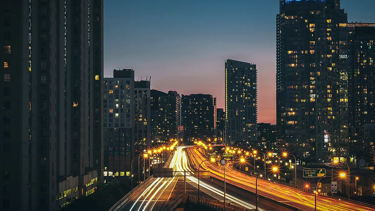 City skyline and highways glowing at dusk