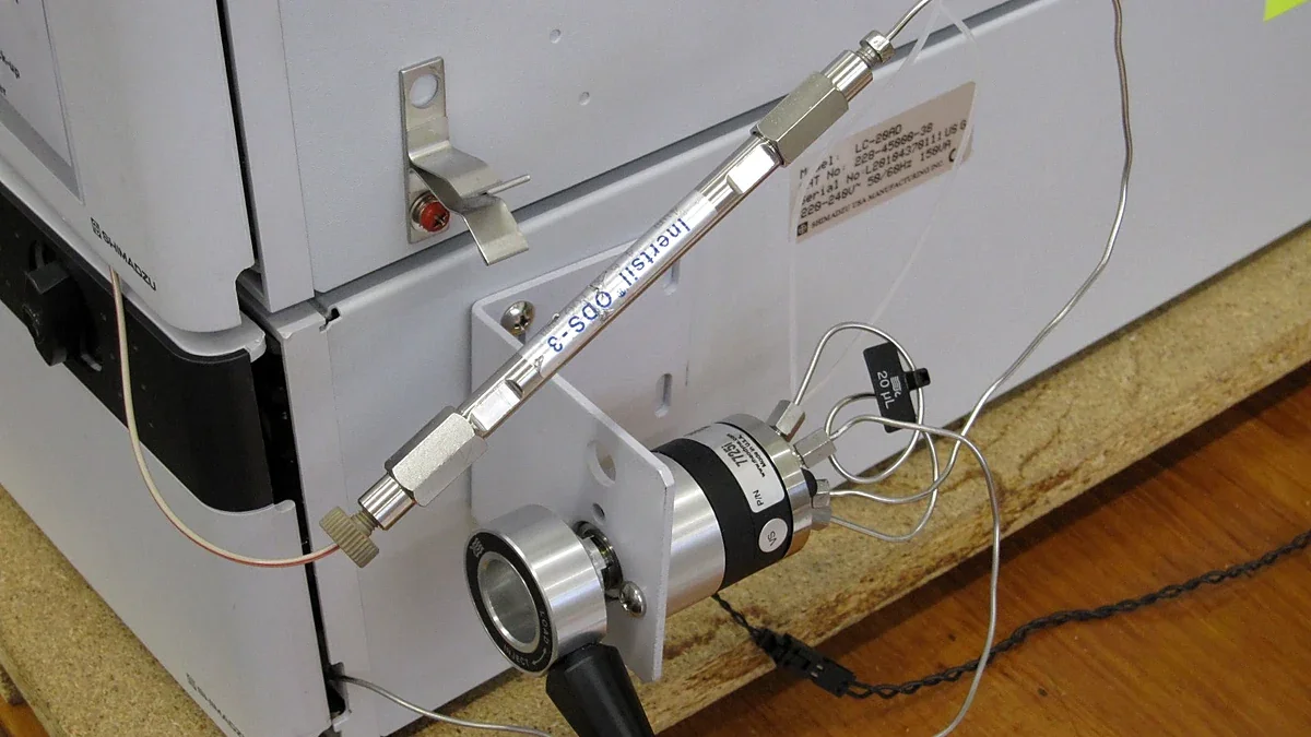 Close view of an HPLC column and its steel fittings