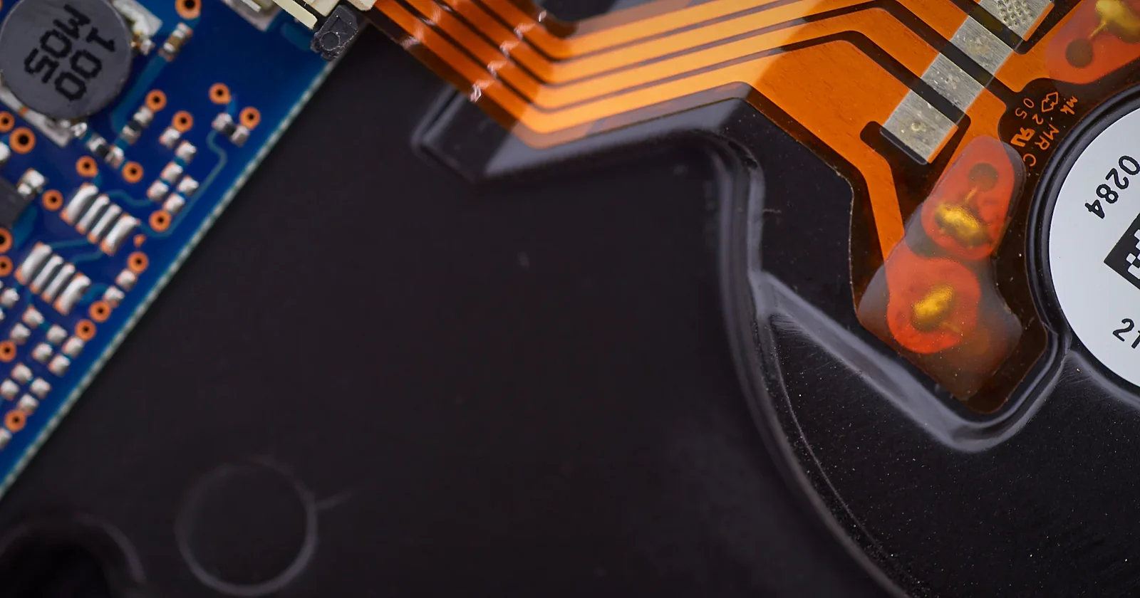 Macro of glowing copper circuit ribbons and connections