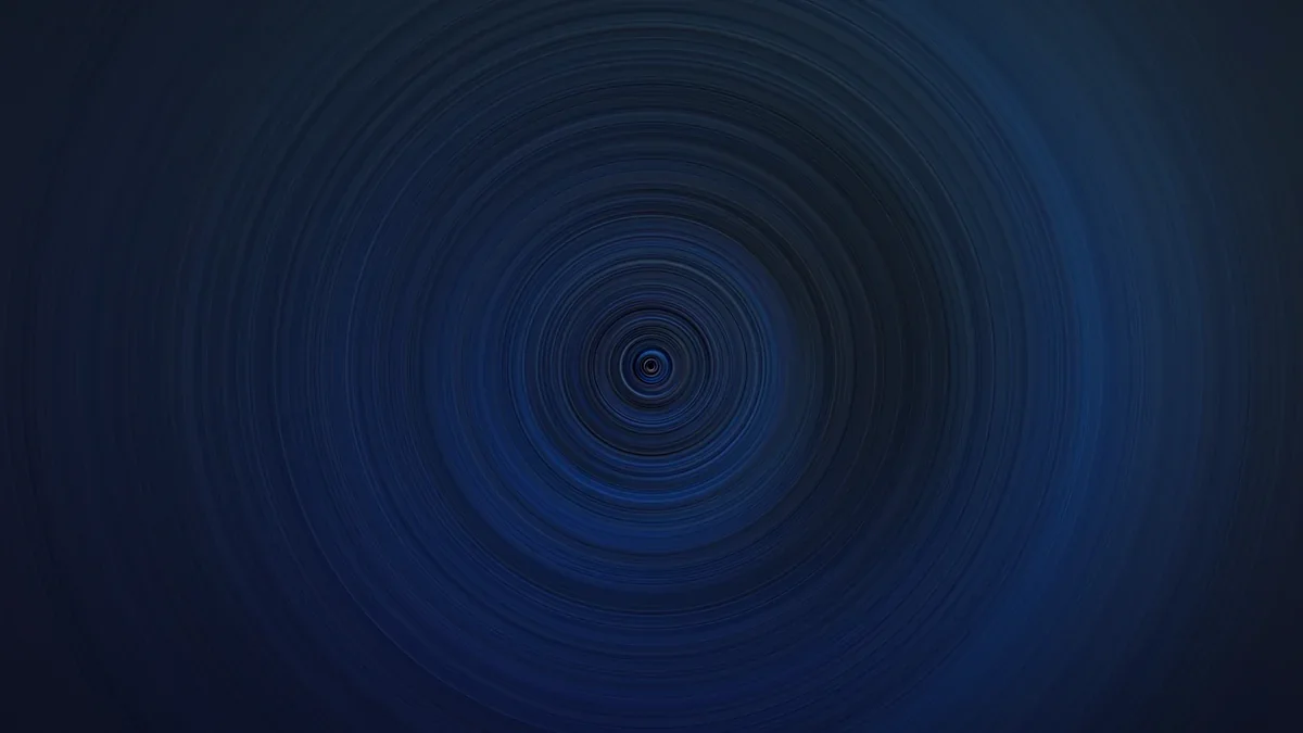 Spiral of electric blue light bursting outward on a dark field