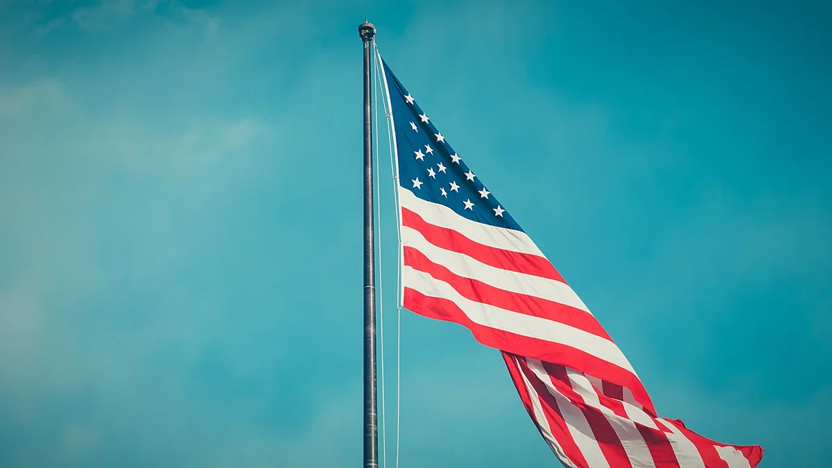 United States flag flying against a bright sky