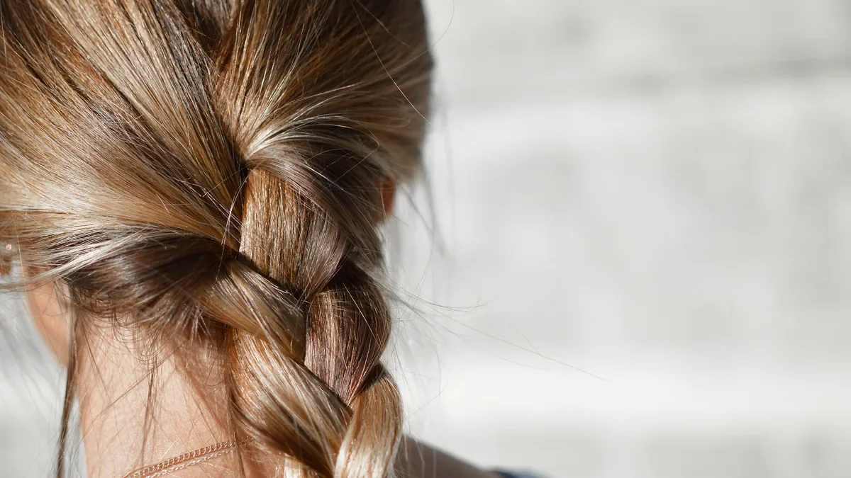 Long braid seen from behind in soft daylight