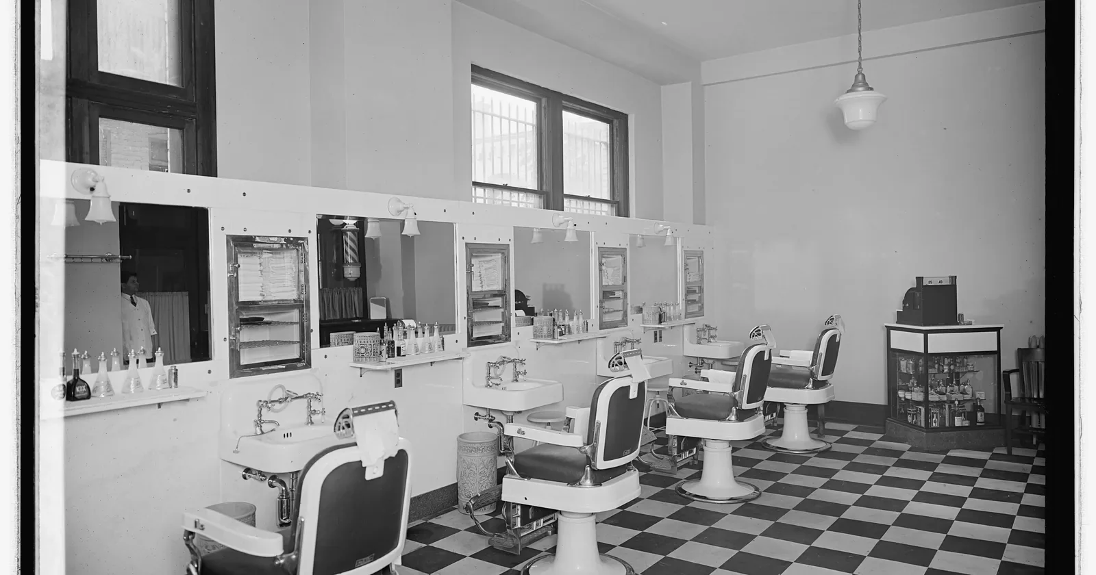 Empty vintage barber shop with white chairs and a checkered floor